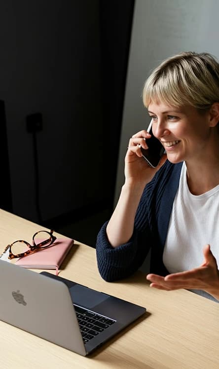 Professional using phone at a modern workspace